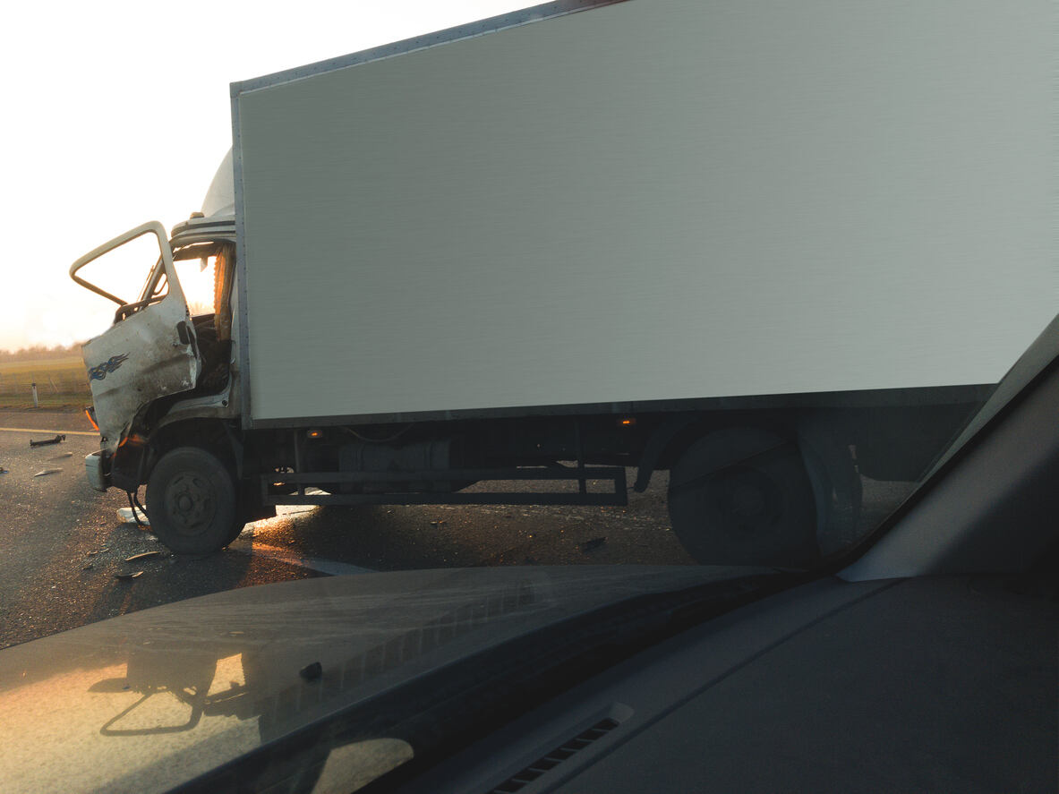 Wrecked white box truck with an open door at an accident scene, showing the aftermath of a delivery truck crash in El Paso, Texas.