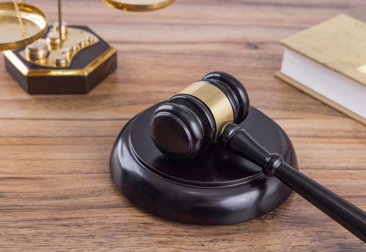 Close-up of a gavel and legal scales, representing the pursuit of justice after a dump truck collision in El Paso, Texas.