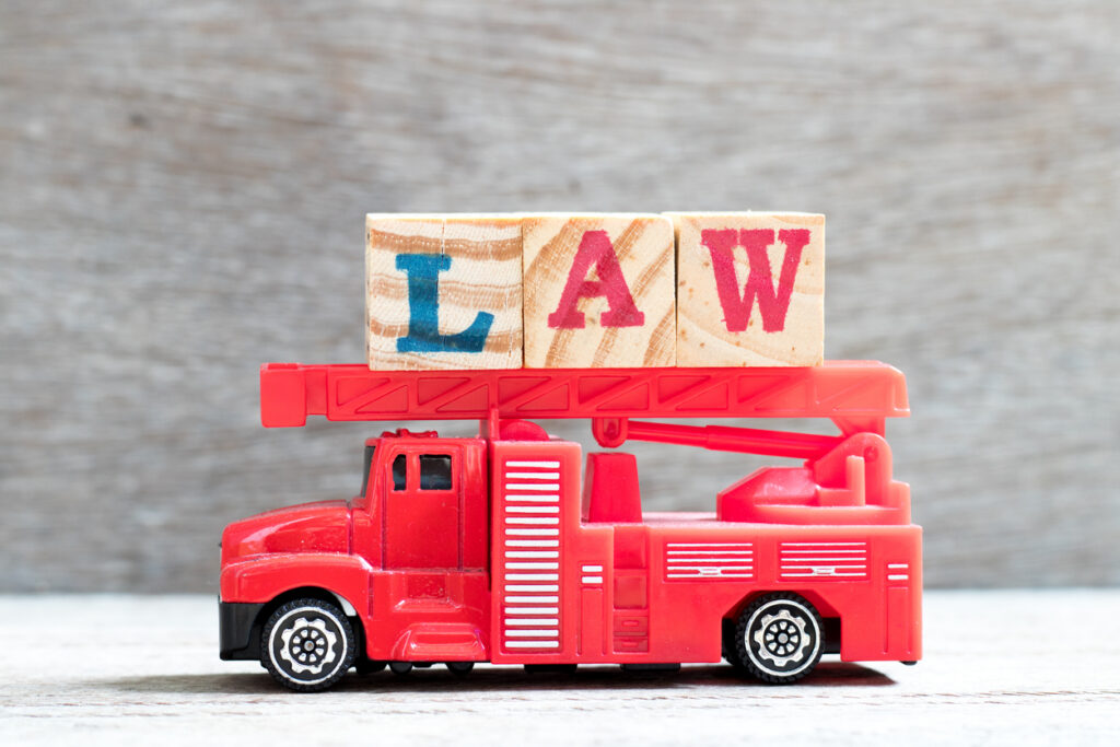 truck hold letter block in word law on wood background